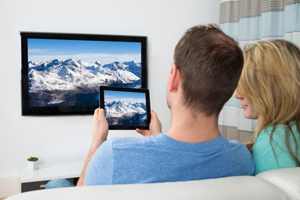 Couple-with-mountains-on-tablet-and-tv