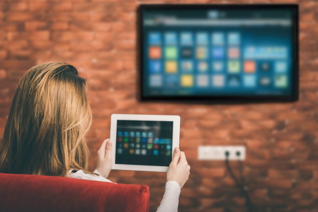 woman-at-home-screensharing-with-tablet-and-tv